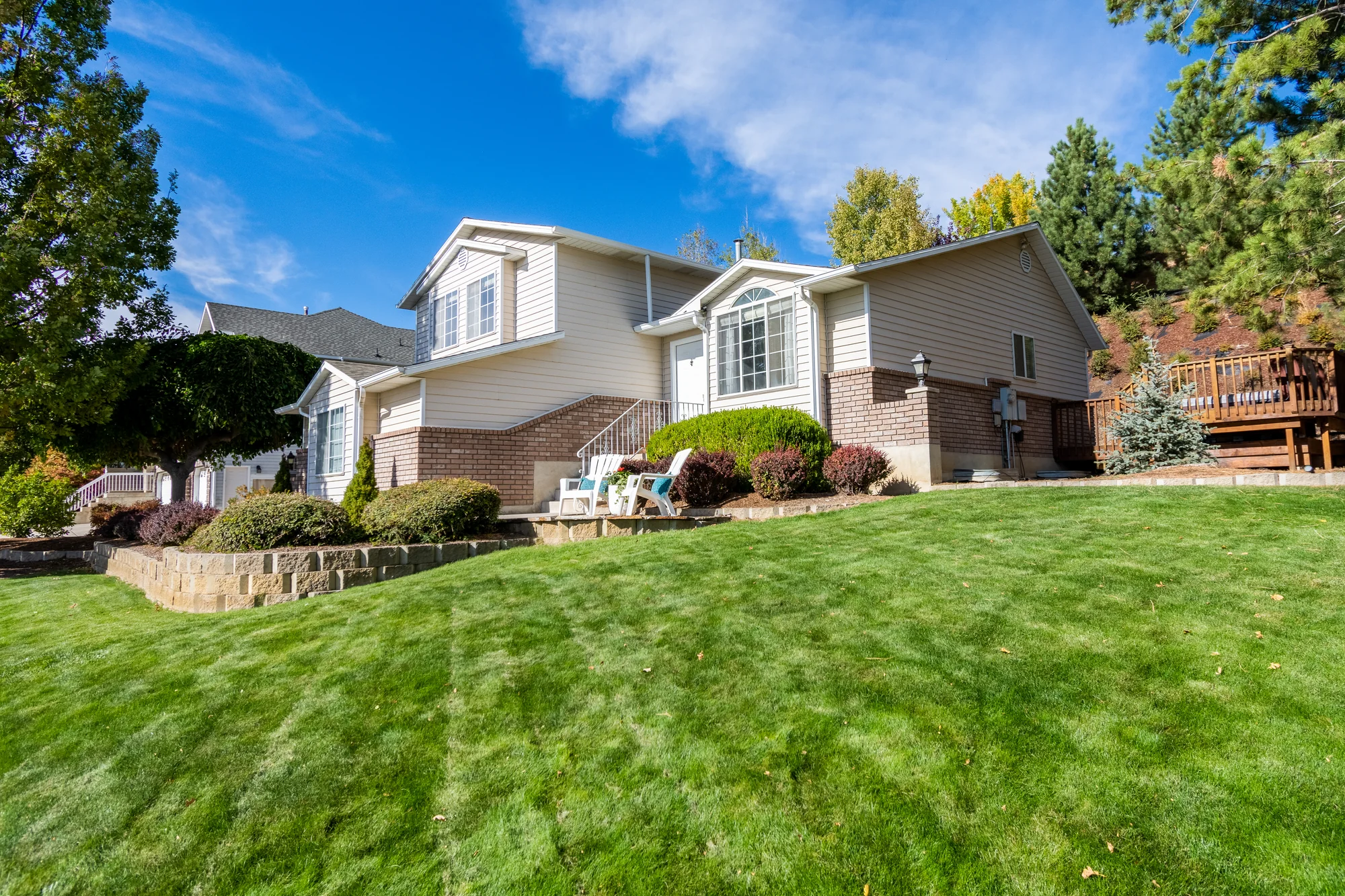 Freshly mowed suburban lawn with clean stripes under a blue sky in Woodbury, MN