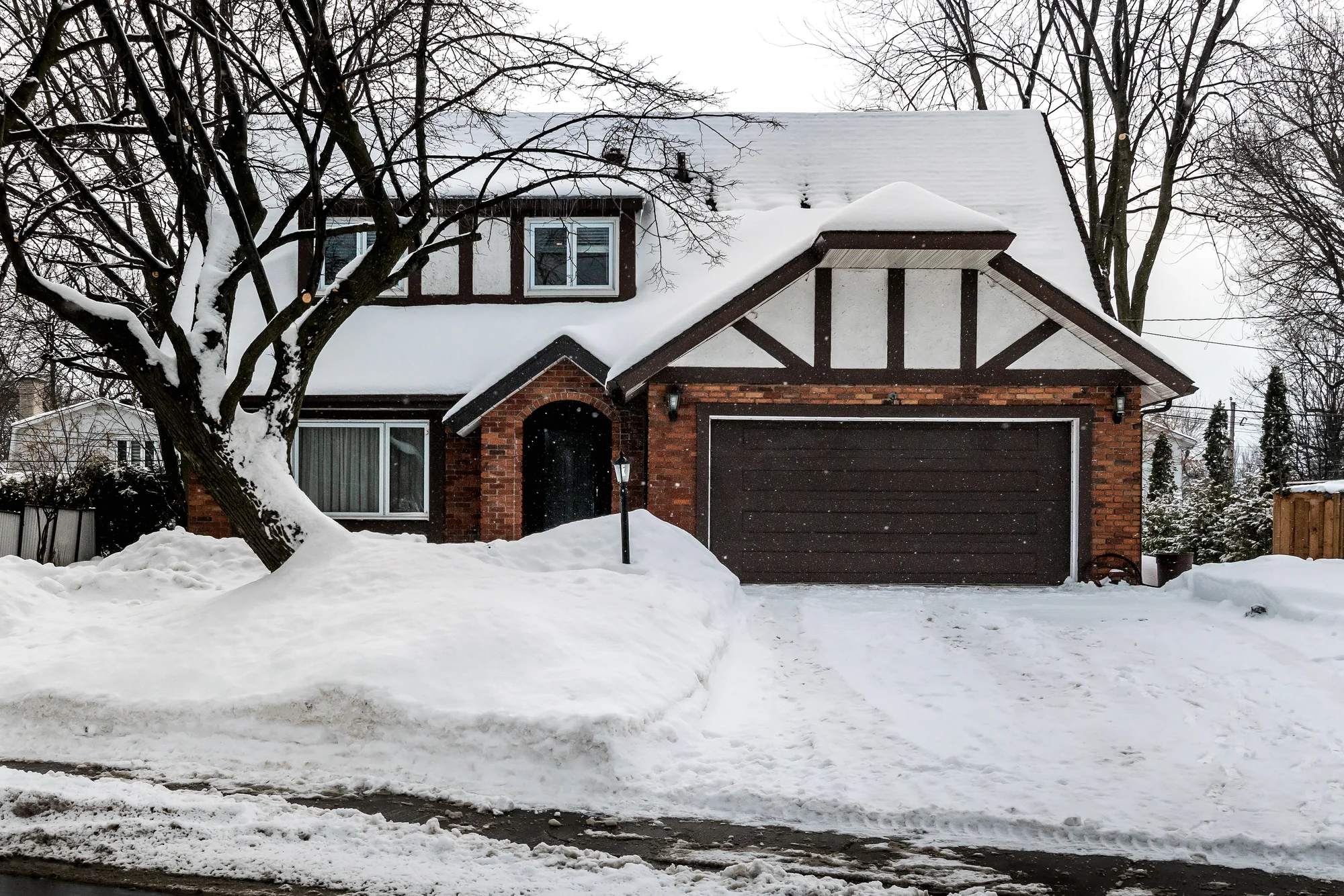 Snow-covered Woodbury home with a cleared driveway after residential snow removal